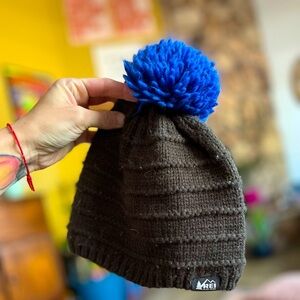 REI youth fuzzy beanie- deep olive with blue pom pom